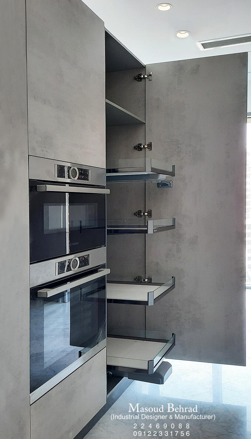 Built-in kitchen cabinet installation with integrated ovens and premium pull-out storage